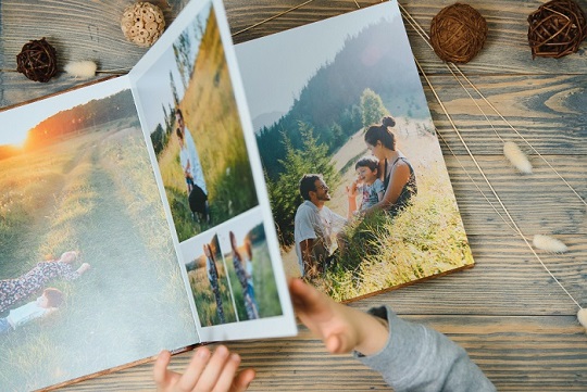 A custom photo and Photo album book with photos of a wedding, birthday and more.